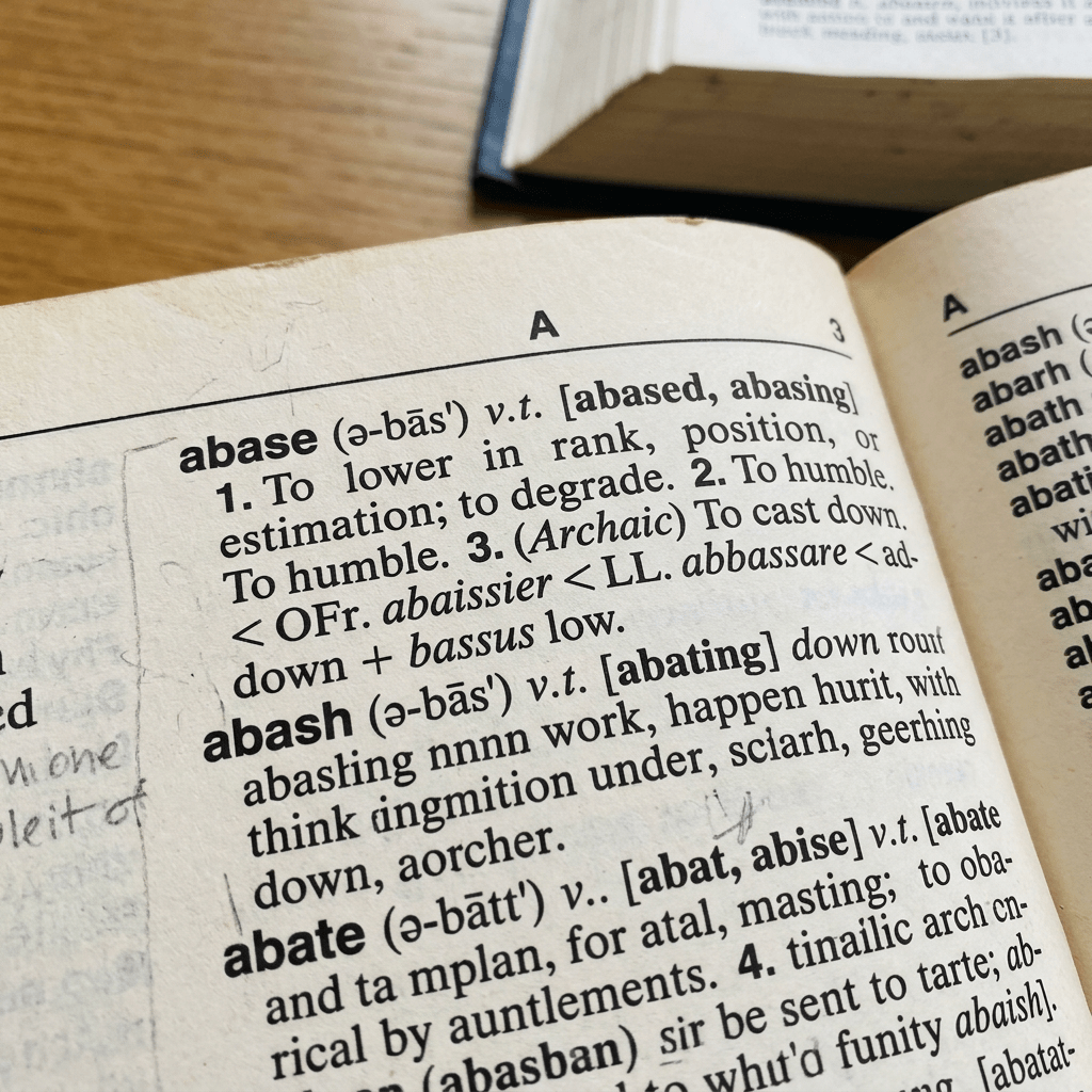 Dictionary page showing definitions of the words abase, abash, and abate with usage and etymology